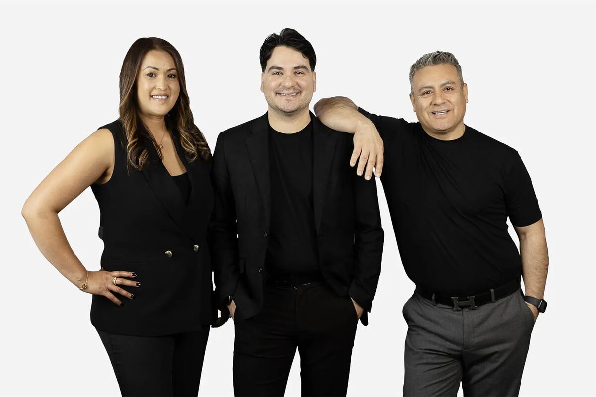 Cristian, Managing Director of Cortes Management Group, on the right, with two fellow members of the agency's leadership team
