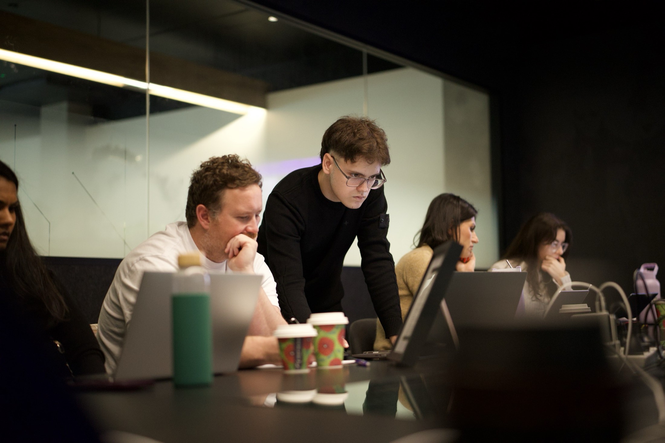 Two Scalify team members reviewing a chat assistant on a laptop