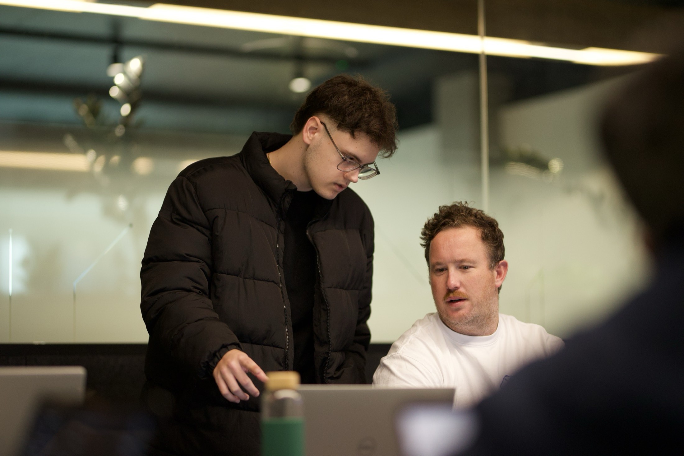 A Scalify developer helping a client work through a build on his laptop