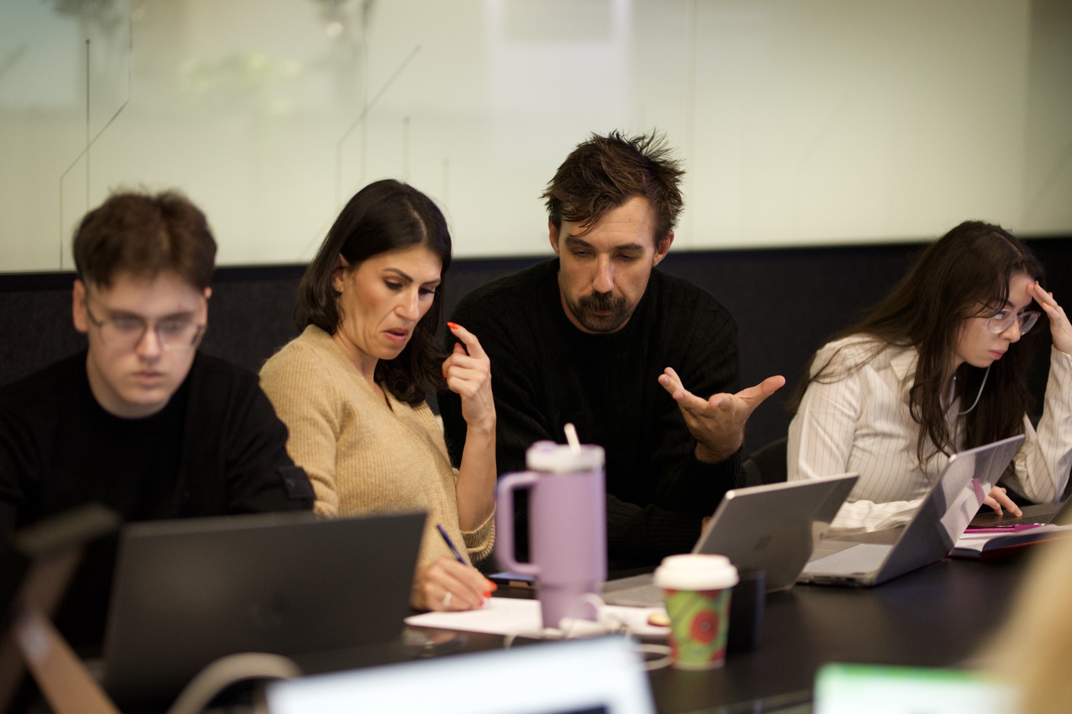 Business owners working through ideas around the table during a Scalify AI strategy session