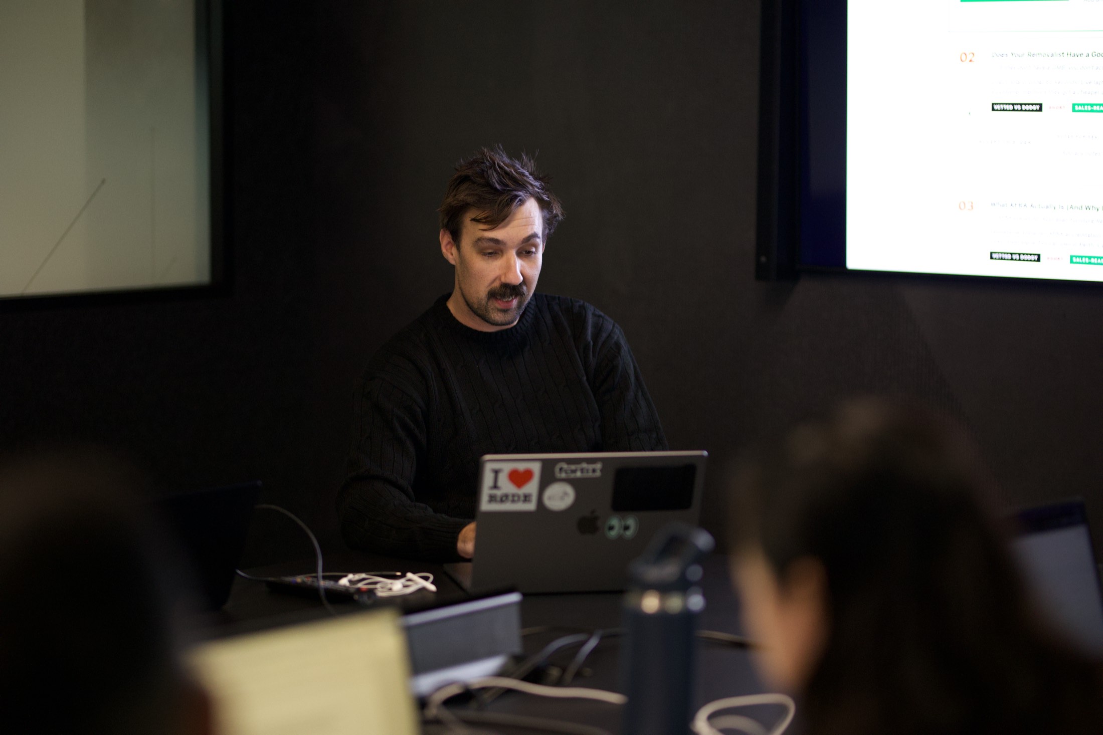 A Scalify trainer running an Azure AI session from his laptop, with a live demo on the screen behind him