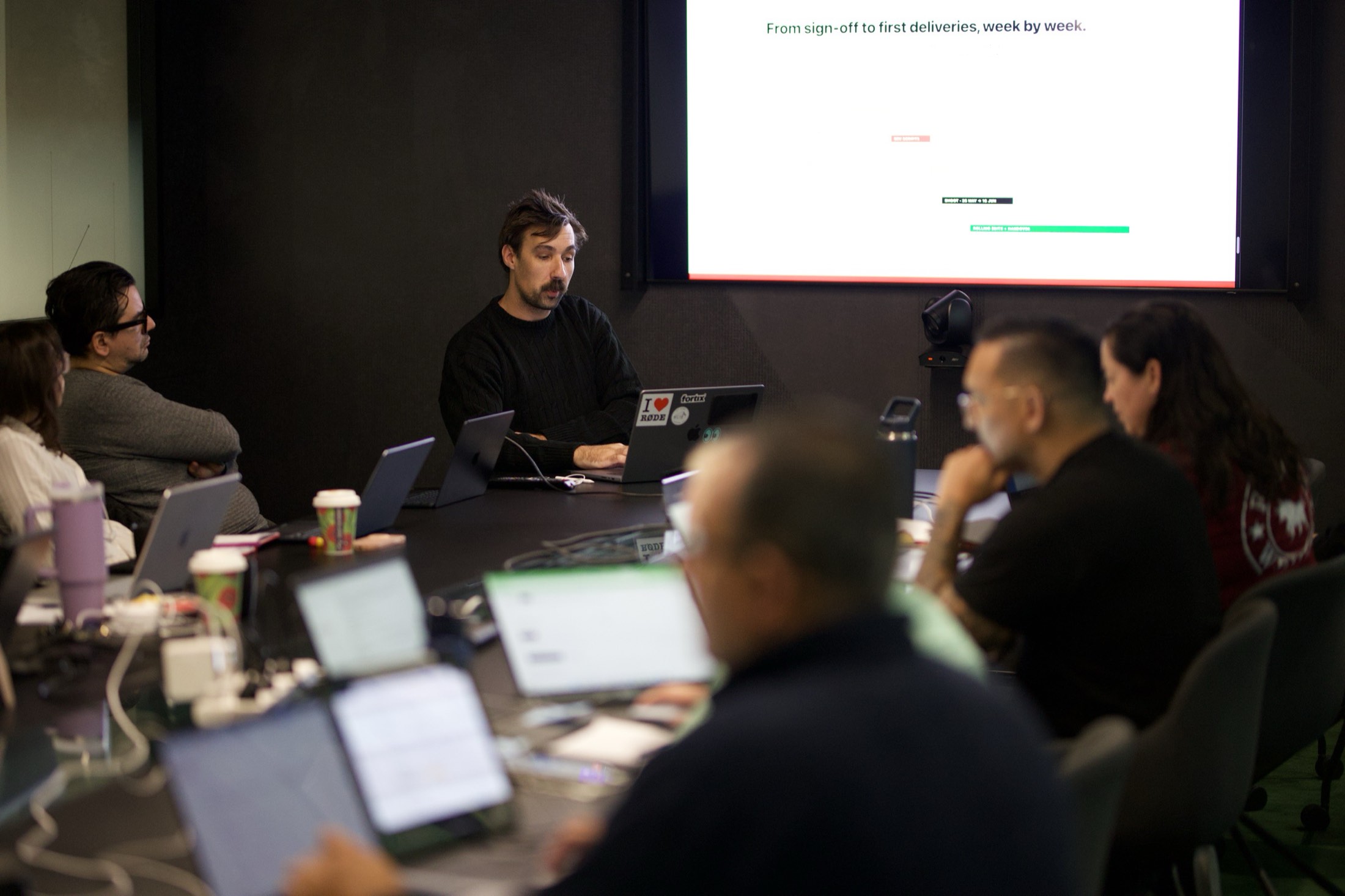 A trainer presenting ChatGPT workflows to a room of staff