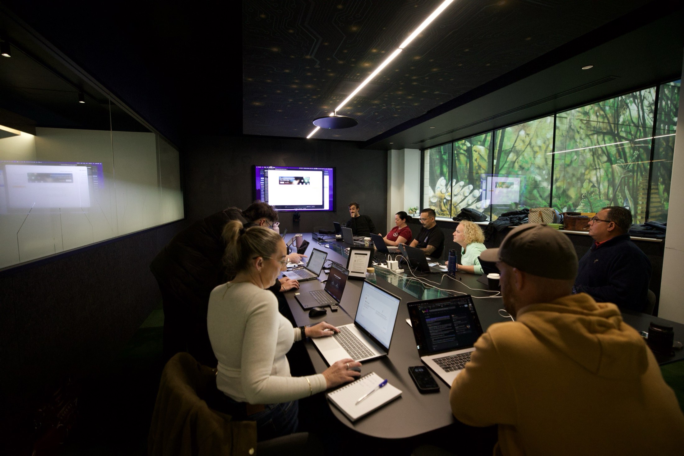 A corporate team at laptops in a boardroom during Scalify AI training