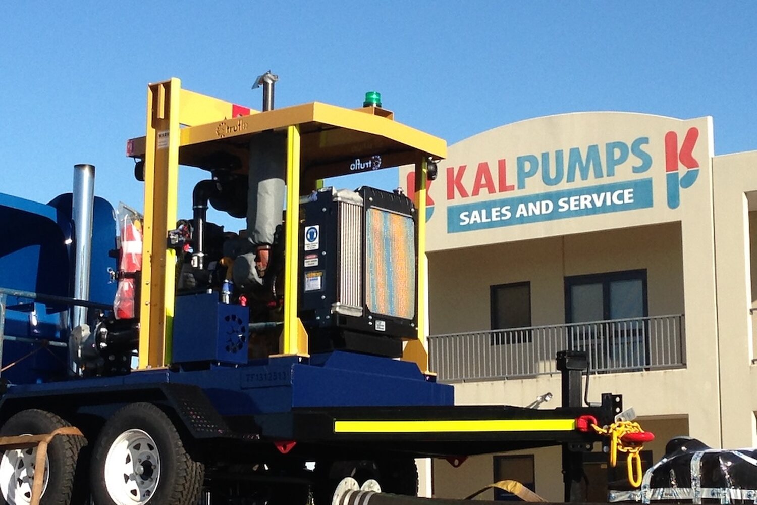 A trailer-mounted diesel pumpset parked outside the Kalpumps Sales and Service building