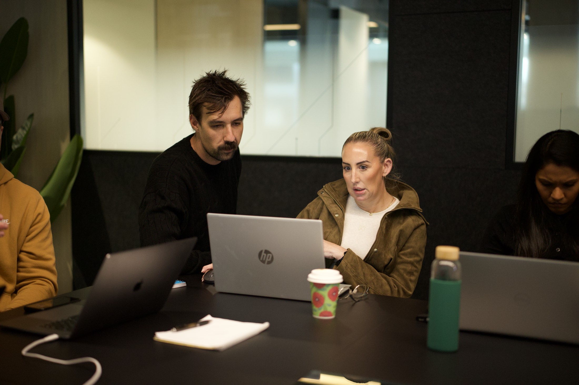 A Scalify consultant helping a workshop attendee build a Power Automate flow on her laptop