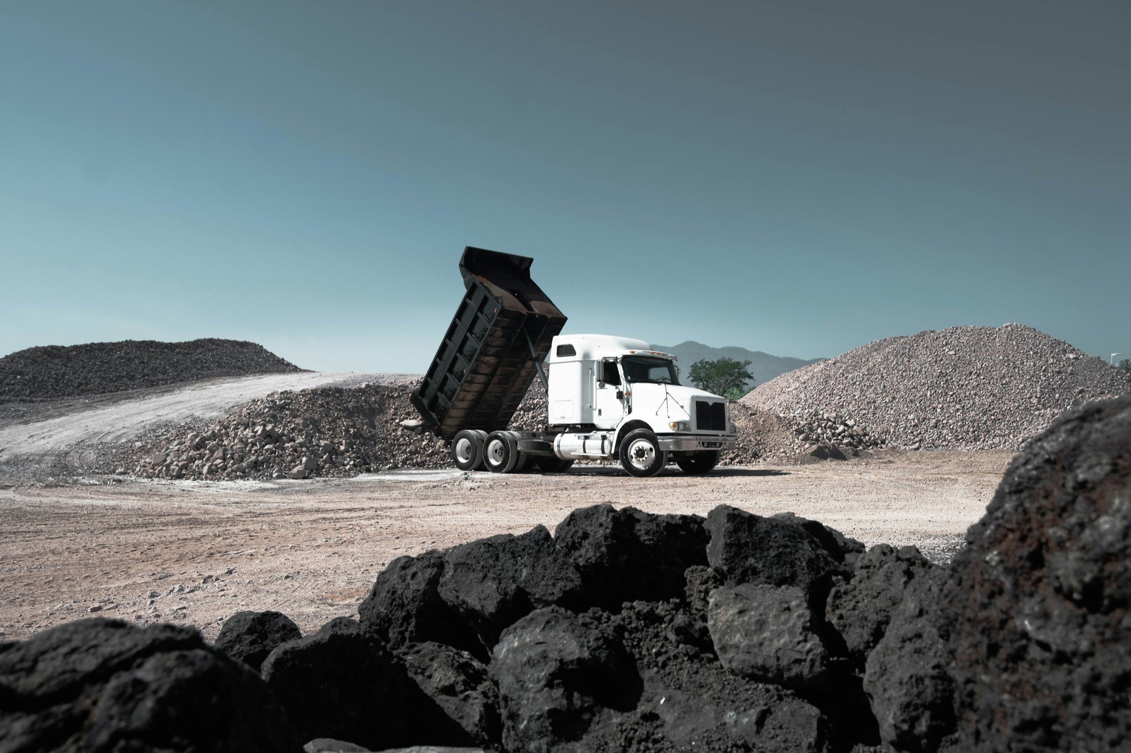 A dump truck tipping rock at a quarry