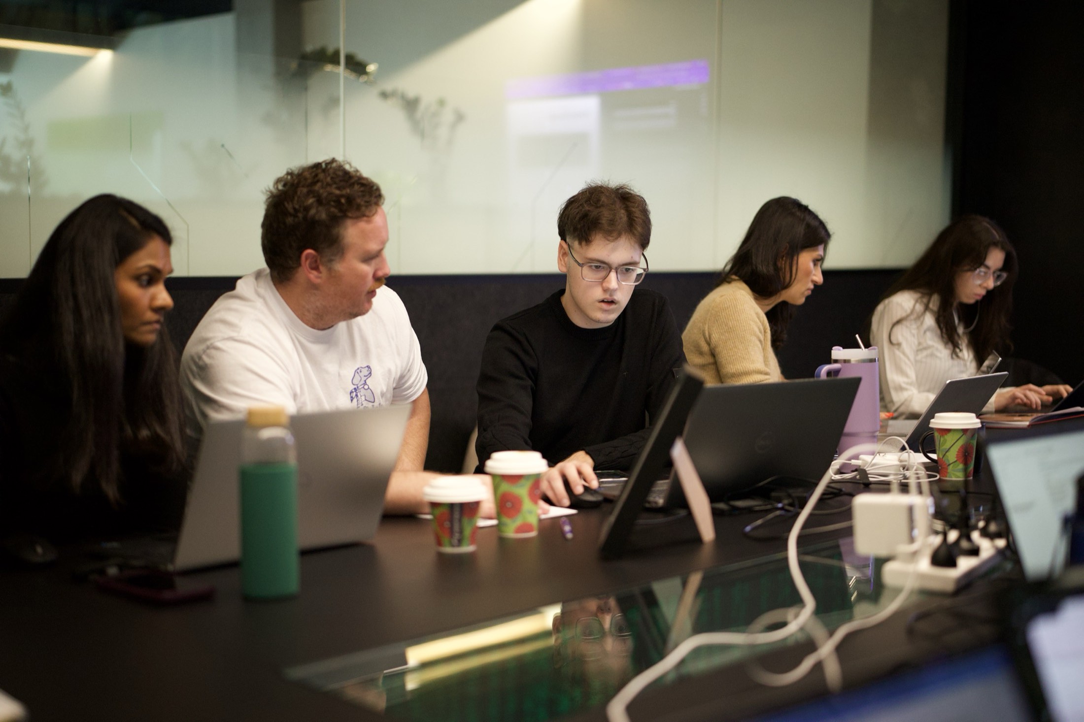 Trainers and staff working together on laptops at a Scalify workshop