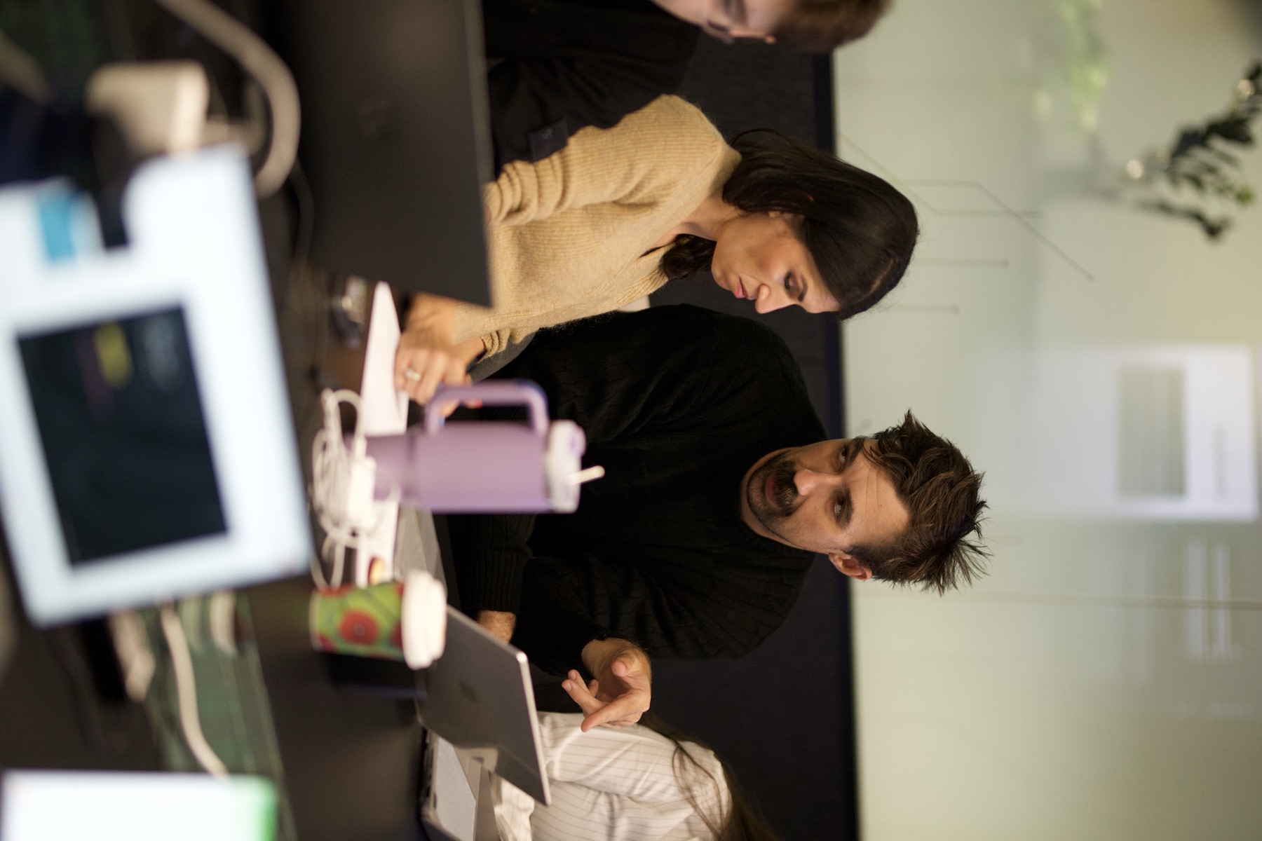 A group working through a briefing together at a boardroom table